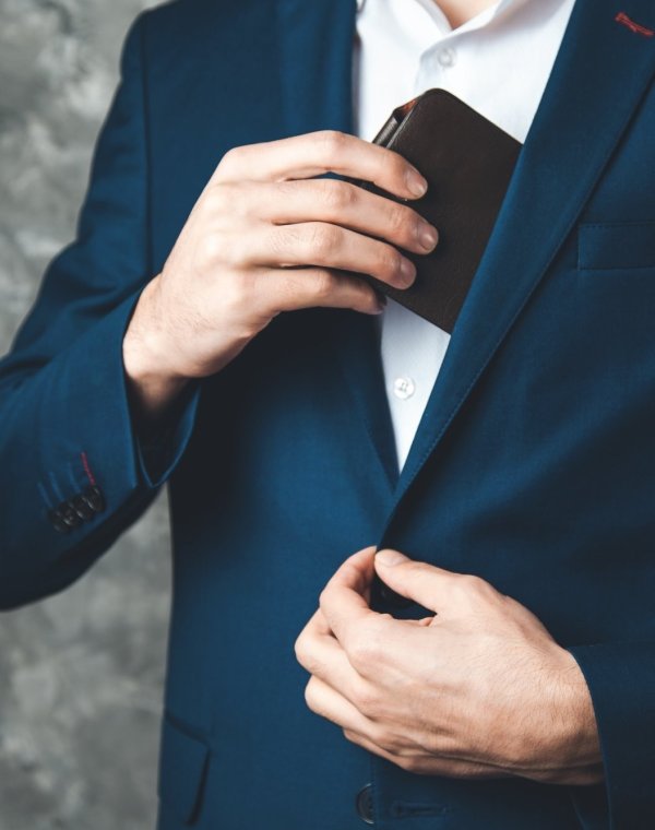 man hand wallet on dark background