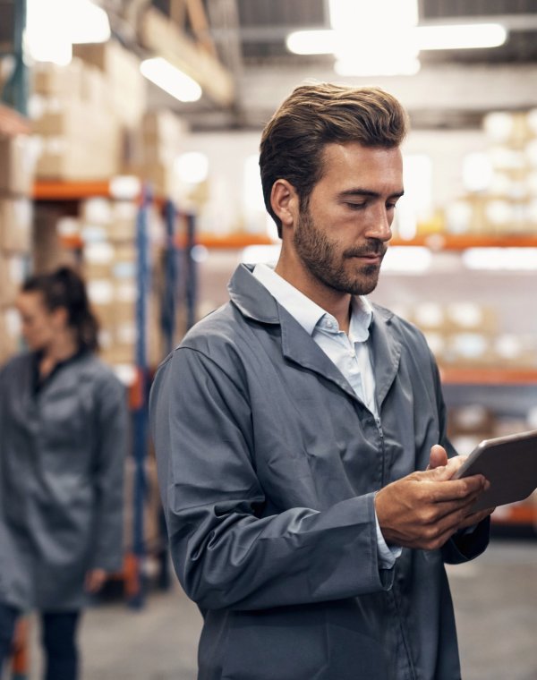Shot of a young man using a digital tablet while working in a warehouse
