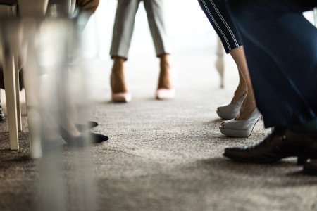 Large group of unrecognizable business people's legs during a meeting.