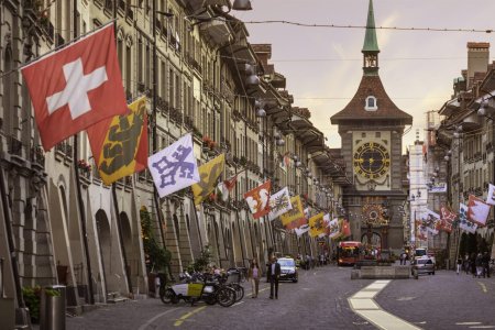 Kramgasse (street) in the medieval old city of Bern in Switzerland, with the 13th century Zytglogge clock tower at the end of the street.