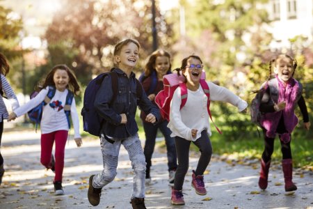 School kids running in schoolyard