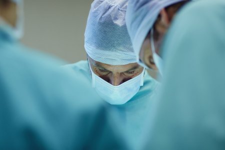 Male surgeons working in operating room at hospital