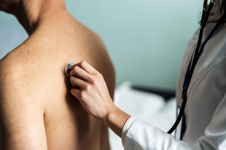 Doctor checking her mature patient's heart during a consultation in a medical center