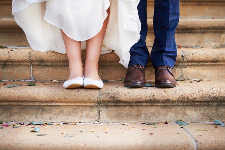 Cropped shot of a couple standing on steps after their wedding ceremony