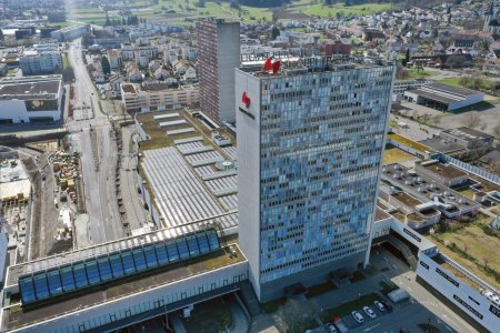 Spreitenbach  in the district of Baden (canton of Aargau) in Switzerland, located in the Limmat Valley. The image shows several residential buildings and the Shoppi Tivoli in the foreground. The high angle image was captured during springtime.