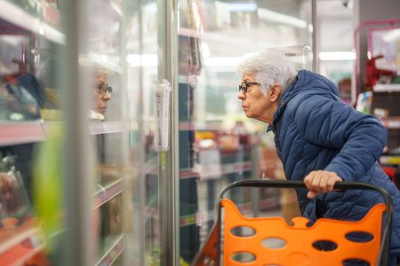 Senior woman shopping in grocery store.