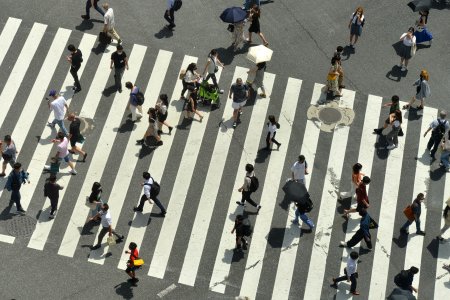Japanese citizens crossing Shibuya Intersection on a hot summerday in Tokyo, Japan