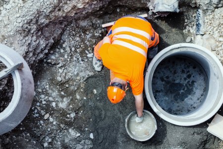 Bern, Switzerland - June 3, 2012 : A construction worker making cement. Civil engineering works in the old town of Bern, photo taken from above.
