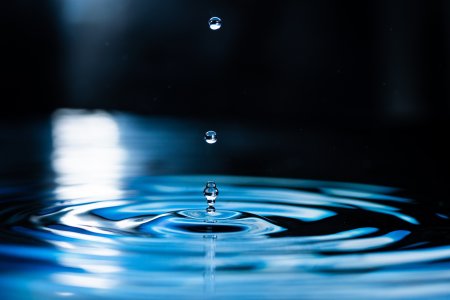 Ripples on water surface with water droplets.