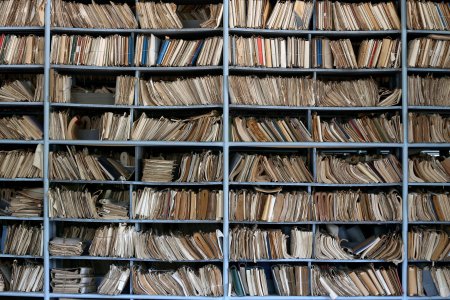 Shelves full of files in a messy old-fashioned archive