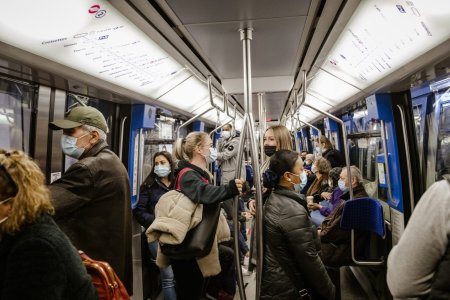 Lausanne, Switzerland - October 25, 2021: Passengers wearing face masks ride the subway in Lausanne.