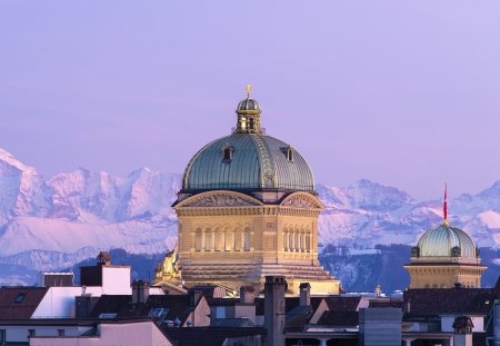 The Federal Palace pictured during the sunset with a beautiful view of the Alps, in Bern, Switzerland, Wednesday, February 13, 2019. (KEYSTONE/Anthony Anex)
