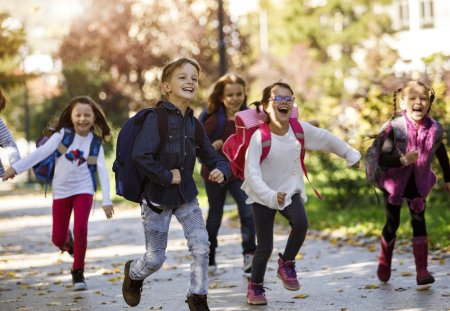 School kids running in schoolyard