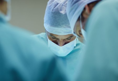 Male surgeons working in operating room at hospital