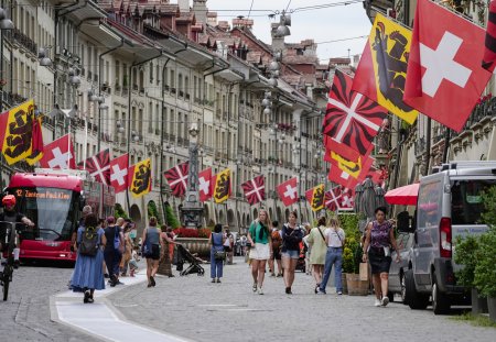Bern, Switzerland - July 22, 2024: Old town view with tourists and Swiss and Canton flags in Kramgasse street in Bern Switzerland