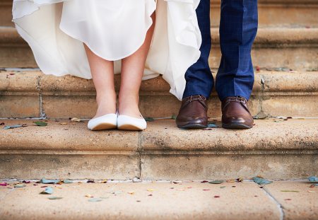 Cropped shot of a couple standing on steps after their wedding ceremony