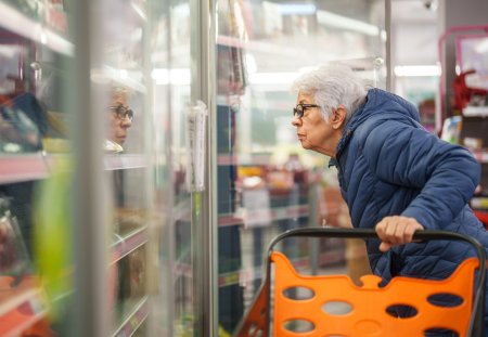 Senior woman shopping in grocery store.