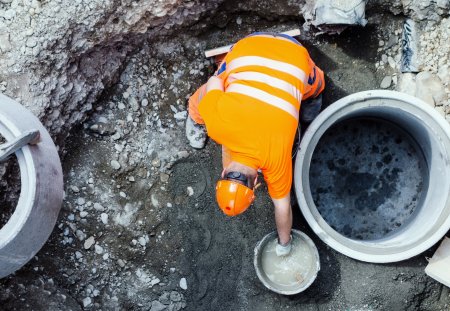Bern, Switzerland - June 3, 2012 : A construction worker making cement. Civil engineering works in the old town of Bern, photo taken from above.