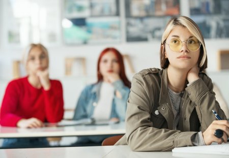 Closeup front view of a high school students in a class listening to the lecture.