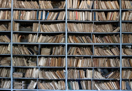 Shelves full of files in a messy old-fashioned archive