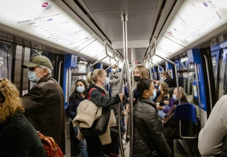 Lausanne, Switzerland - October 25, 2021: Passengers wearing face masks ride the subway in Lausanne.