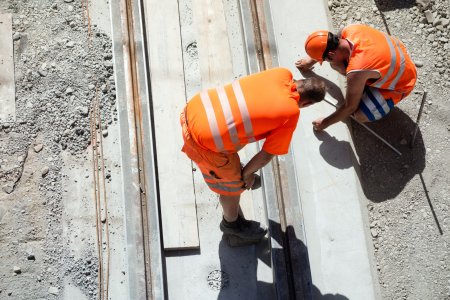 Bern, Switzerland - June 18, 2012 : Two construction workers or engineers on track construction in the old town of Bern, aerial view.