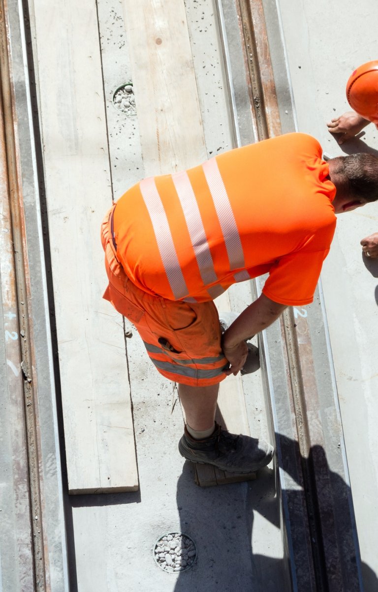 Bern, Switzerland - June 18, 2012 : Two construction workers or engineers on track construction in the old town of Bern, aerial view.